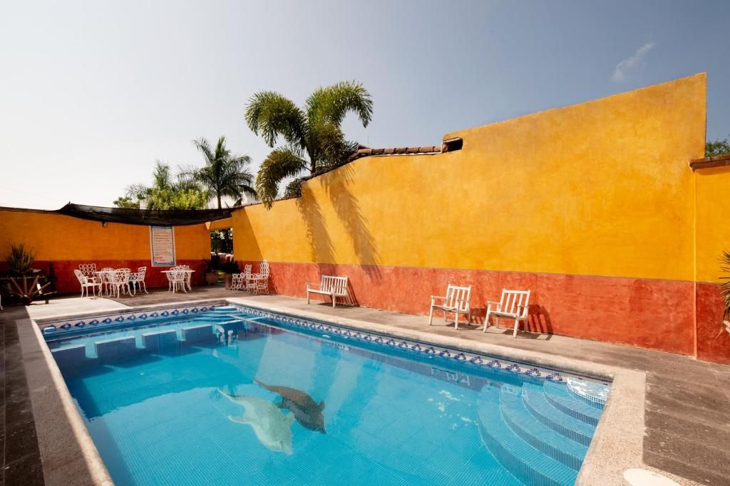 Hotel outdoor swimming pool with traditional courtyard walls